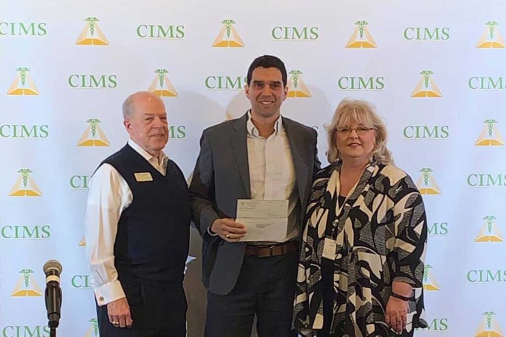 CIMS Best Practices Event three people accepting an award